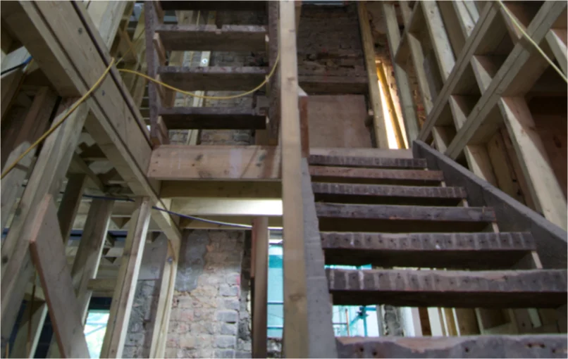 This image depicts the inside of the building and a temporary wooden staircase built to get to the top.