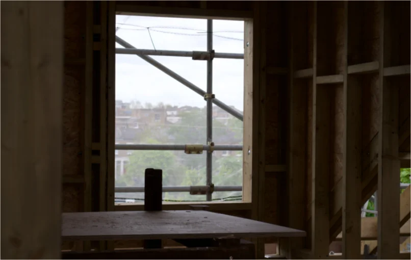 This image depicts the inside of the loft conversion focusing on a hole left behind to put in a new window.